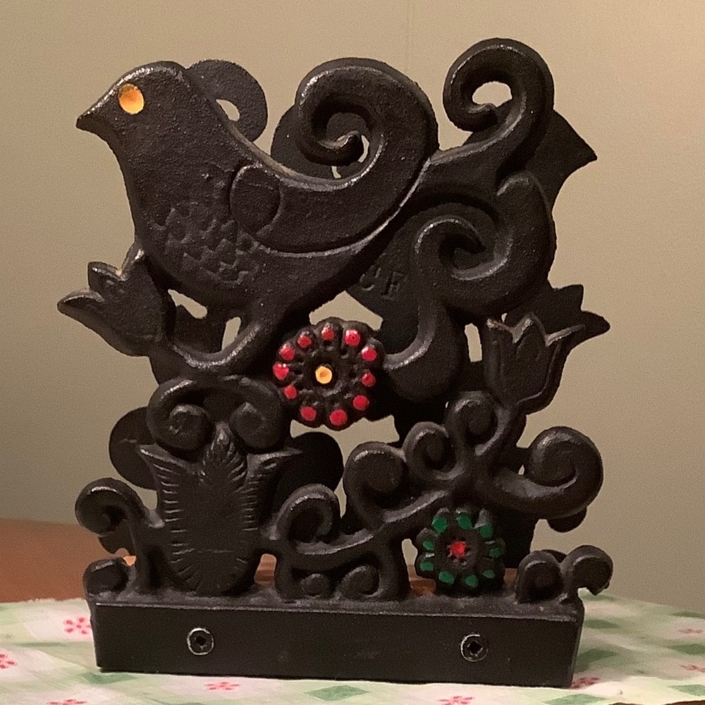 Cast iron napkin holder with enamel colours.